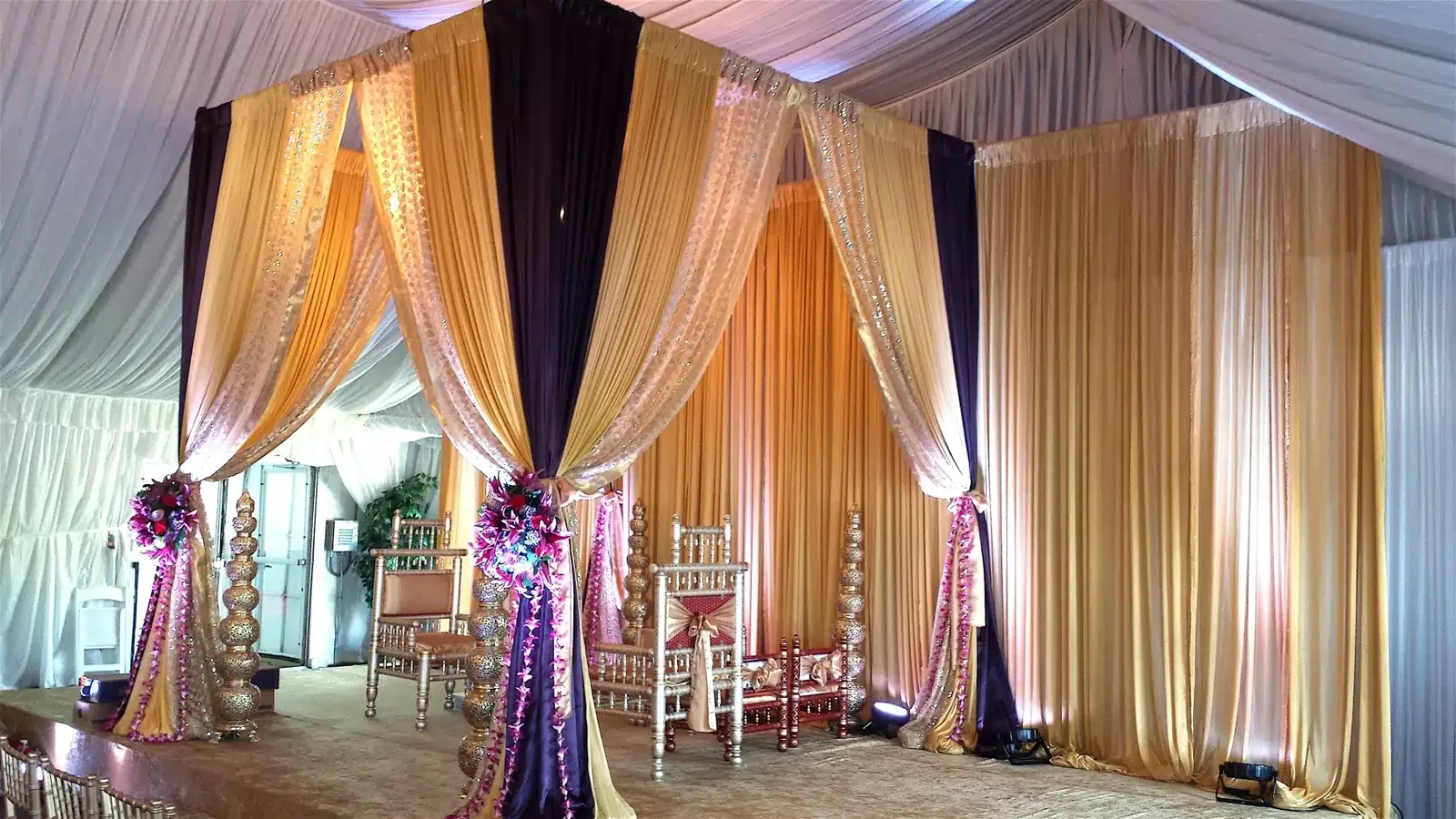 Fabric mandap with floral accents for Hindu wedding ceremony