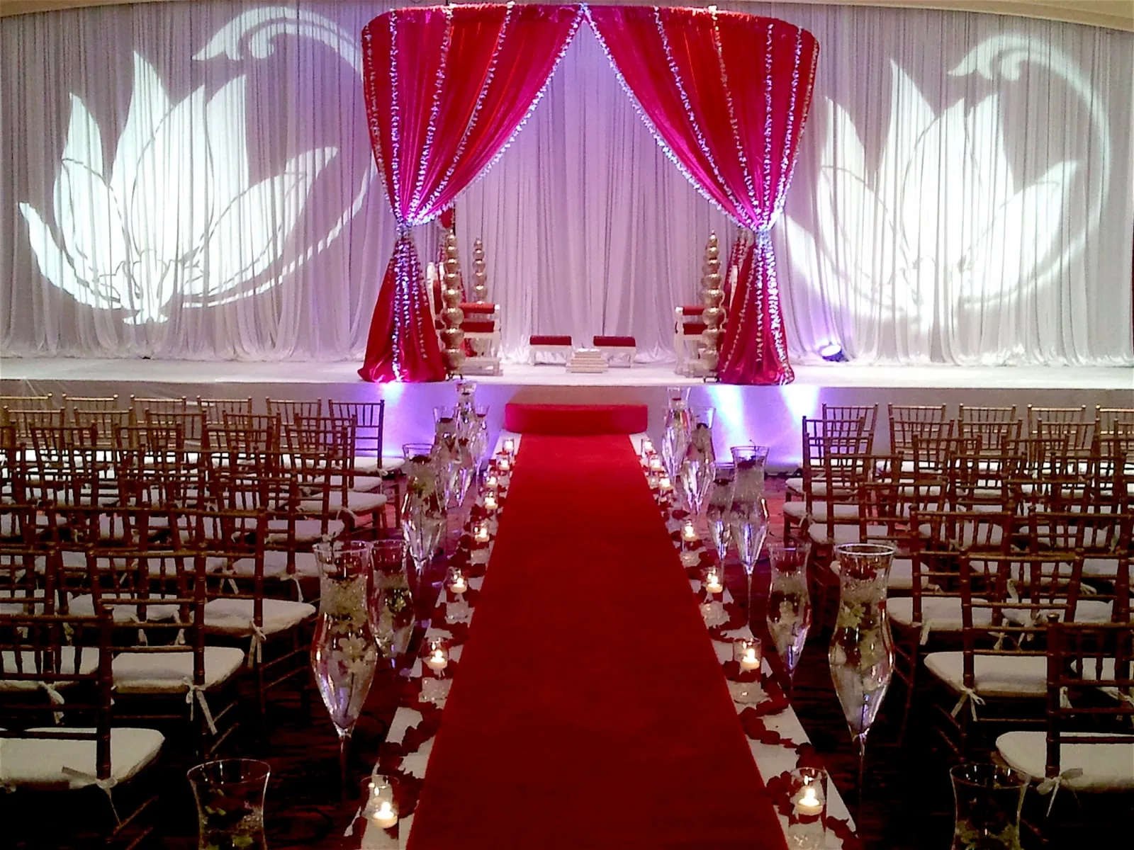 Fabric mandap with rich red draping for traditional Indian wedding