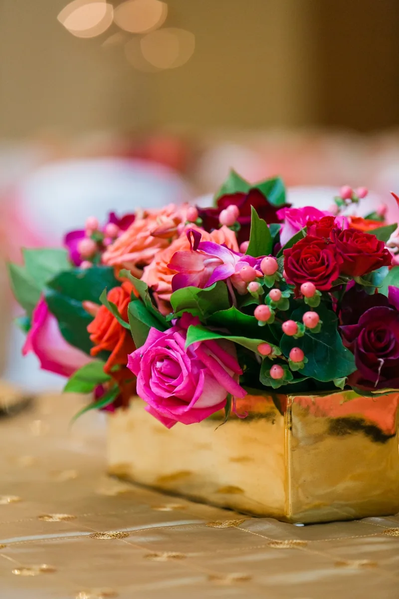 Gorgeous pink and red centerpieces at Indian wedding reception